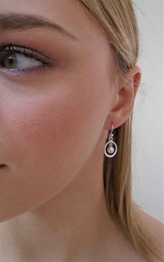 circle and bead drop earrings on model